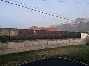Ornamental iron fence on retaining wall