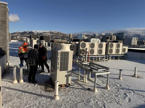 All Around Cooling & Heating crew working on a commercial rooftop HVAC installation in Salt Lake City.