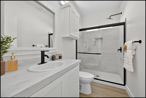Gallery Image modern-white-bathroom-with-black-fixtures-walk-in-shower.jpg