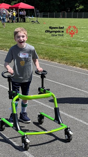 a young athlete competing in a track event, that smile says it all!