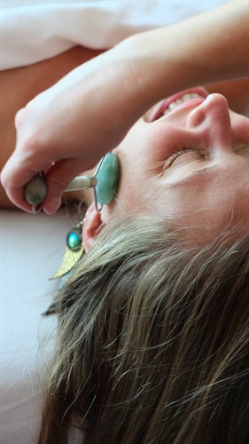 Gallery Image female_client_jade_roller_facial_16x9(1).jpg