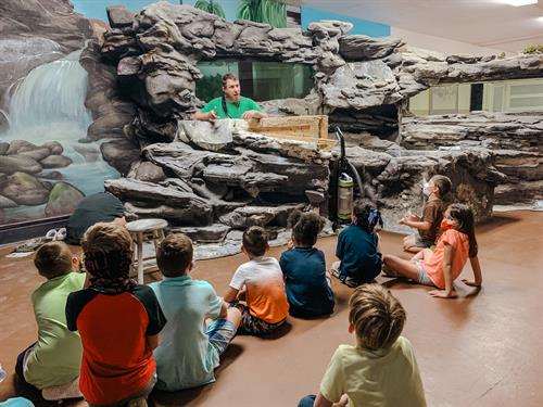 Geoff Schenkel teaching children at Ely Chapman Education Foundation using the Living Rivers Water Display and Mural. Restoration was partially funded by MCF.
