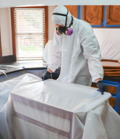 Certified biohazard and asbestos cleanup professional setting up safe containment at a property. Certified biohazard and asbestos cleanup professional setting up safe containment at a property.