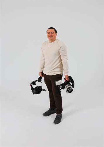 Gage Horne Holding His Camera Gear