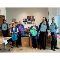 Franciscan Health Michigan City staff and volunteers fill backpacks with supplies in preparation for