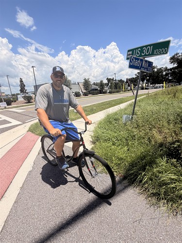 Attorney Frank Santini riding a bicycle on US 301 in Riverview, Florida, as part of his work on bicycle and e-bike safety.
