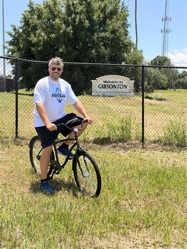 Attorney Frank Santini riding a bicycle in Gibsonton, Florida, while conducting local bicycle and e-bike safety research.