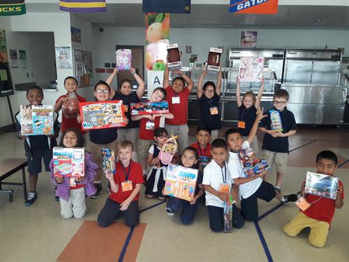 Ruskin students with rewards earned from the At-Home reading initiative