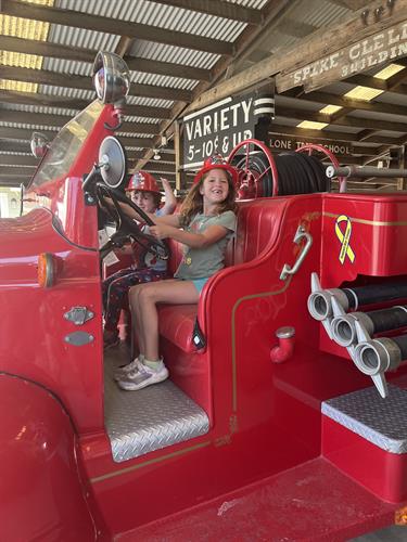 Nothing brings a smile like sitting on a fire engine!  Thanks to Zeigler Insurance for donation of fire hats!