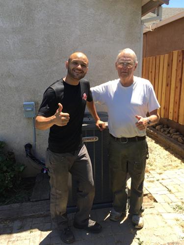 Lead Service Technician, Gilbert Caceres with a very satisfied client after installing a new Lennox heating and air conditioning system.