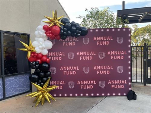 Client provided backdrop + 10 foot balloon garland with gold starburst foil balloons.
