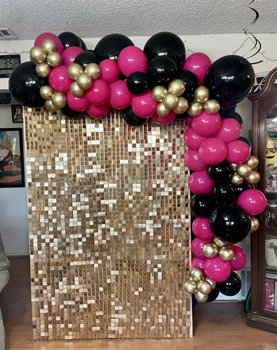 Champagne shimmer wall rental + 8 foot balloon garland.