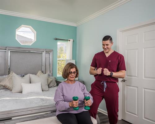 Occupational therapist exercising with stroke client.