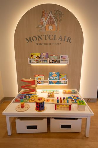 Play corner, filling up with books and Montessori-inspired toys