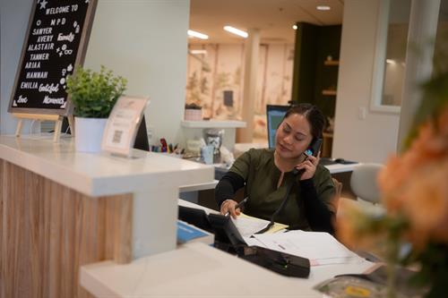 Our friendly front desk coordinator Marcela taking calls and filling up our schedule!