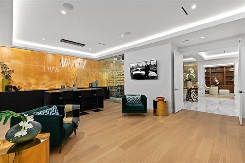 Hardwood flooring, Bar kitchen, Natural countertop, Onyx with back lighting on the wall