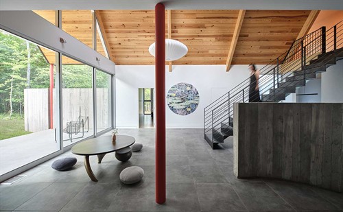 Located in a rural landscape, Dogtrot House is an ode to the outdoors.  Living spaces are organized around a central indoor-outdoor breezeway that extends to create shaded porches, allowing natural ventilation and views throughout the home.