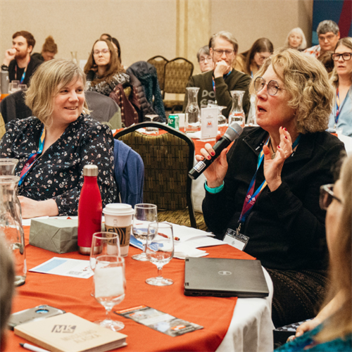 Conference participants asking questions.