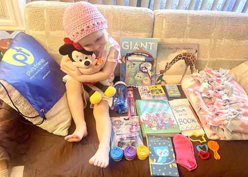 Gallery Image child_with_care_package_contents.jpg