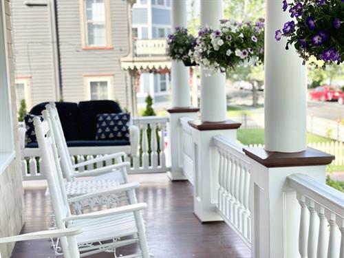 Quintessential Cape May front porch with rocking chairs.