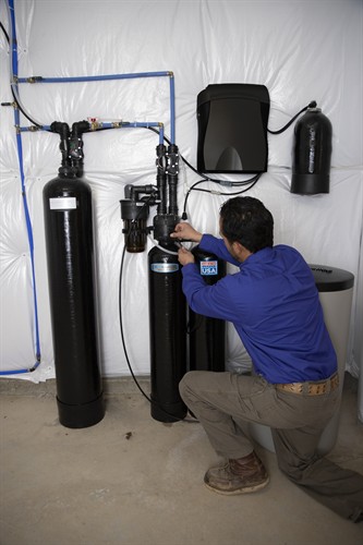 Gallery Image Technician_Adjusts_Softener_Black_PRINT.jpg