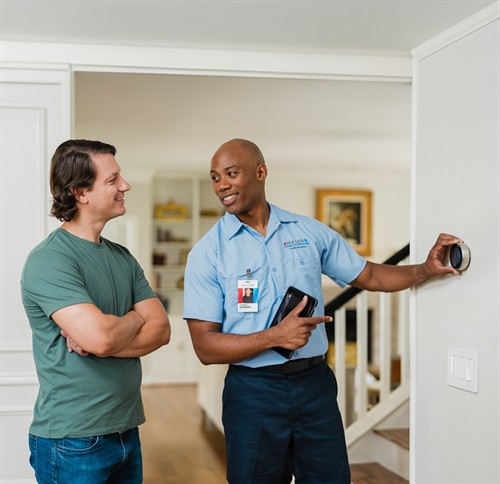 Licensed Aire Serv technician explaining HVAC repair options with upfront, by-the-job pricing
