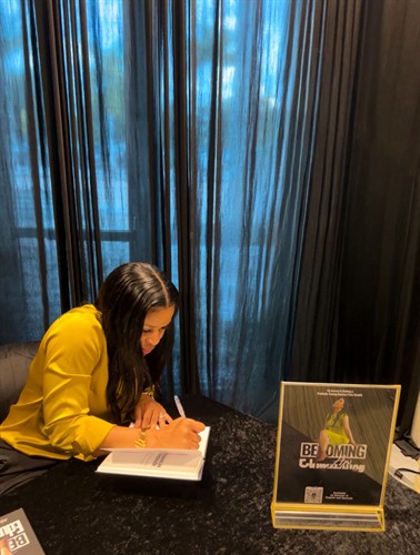Gallery Image Alicia_signing_book_.jpg