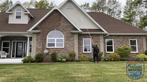 Pressure washing vinyl siding.