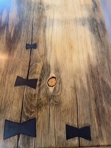 Steel bowties to tie together this pine slab coffee table.  Finished with a smooth to touch epoxy resin.