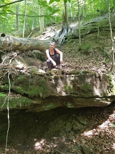 Host Laura off trail exploring caves and seasonal waterfalls at Bear Cave Camp