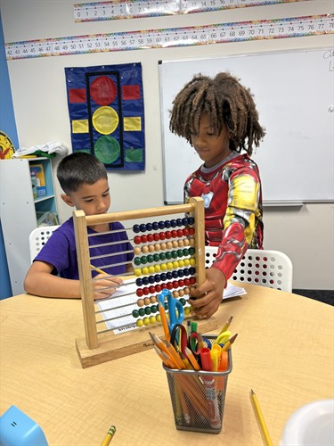 students working together on a hands-on math lesson