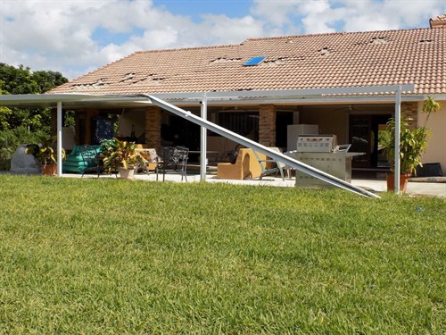 Hurricane wind damage to a patio cover in Miami, FL