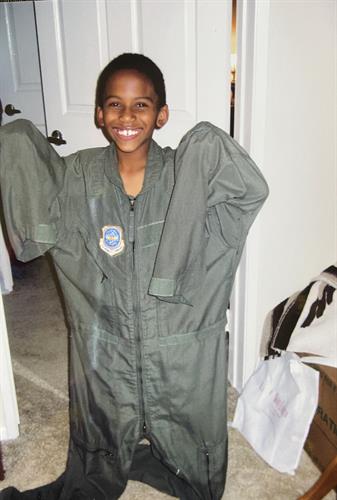 My son trying on Uncles flight suit 