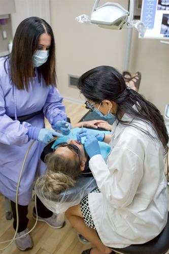 Dr. Dhillon and her assistant Bea treating one of our patients