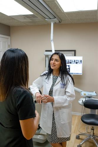 Dr. Dhillon discussing treatment with one of our patients