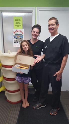 Doctor Hamilton with C.A. Muriel & his daughter celebrating a gift from one of our amazing patients!