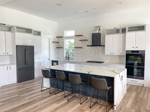 This Remodel features Venetian black quartz countertops and Blanco Cabinets by Lioher. 