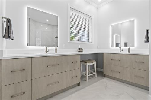 We are thrilled to showcase our latest project, where we not only remodeled this client's kitchen but also transformed two bathrooms and converted a bedroom into a  kids playroom for their grandchildren. The heart of the home, the kitchen, features stunning cabinetry by Lioher in Blanco & Nocce 1,complemented by exquisite Calacatta Supreme quartz countertops.