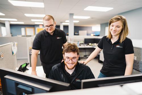 Teamwork in motion: Clarity Technicians collaborating on a customer service request.