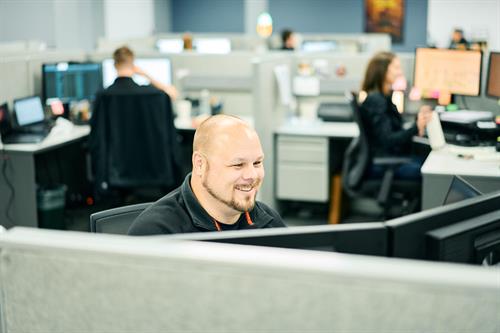 A busy day at Clarity—focused work happening across the office, Technician Brandon is keeping clients supported and systems strong.