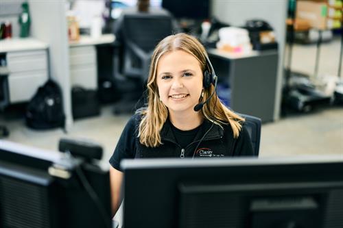 Headset on and screens up—Clarity Service Coordinator, Amanda, in motion, keeping systems steady and clients connected.