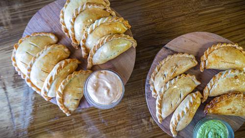 Baked Empanadas: Handmade savory pastries filled with chicken or ground beef.