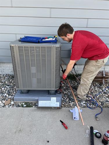 Installer Rick finishing up an AC installation.