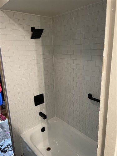 Completed Bath tub refinish with new drywall, tub surround and plumbing fixtures