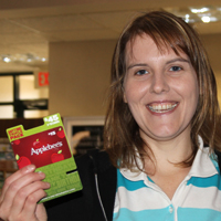 An RFCU member displays her winnings from spinning the wheel at our 2012 International Credit Union Day.