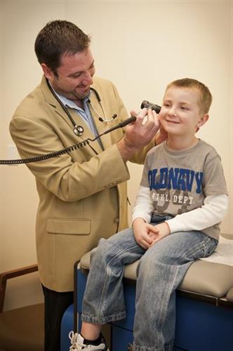 Dr. Sean McEnaney caring for a pediatric patient at his Rolla practice.