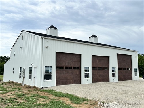 White Metal Two Story Garage with Charcoal Roof