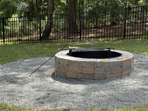 Professional wood burning firepit installation in Chapin, South Carolina.