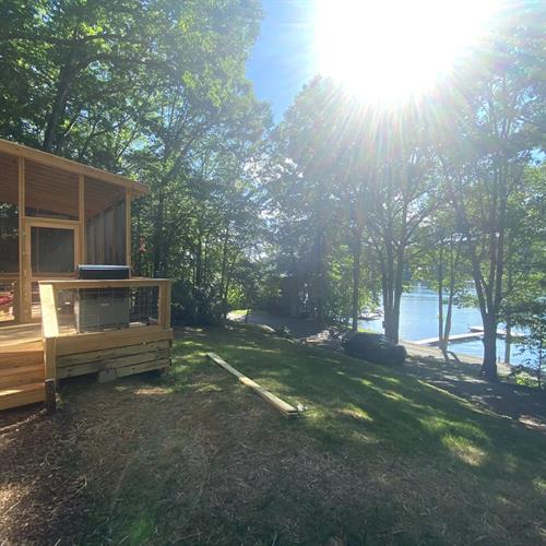Our luxury tiny house is nestled into the woods with sunset views over Licklog Cove.