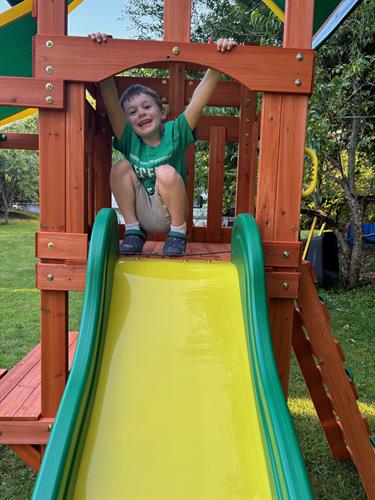 Smiles for miles! This little one was thrilled with his new swingset, made possible with funding from Step Up Parents.